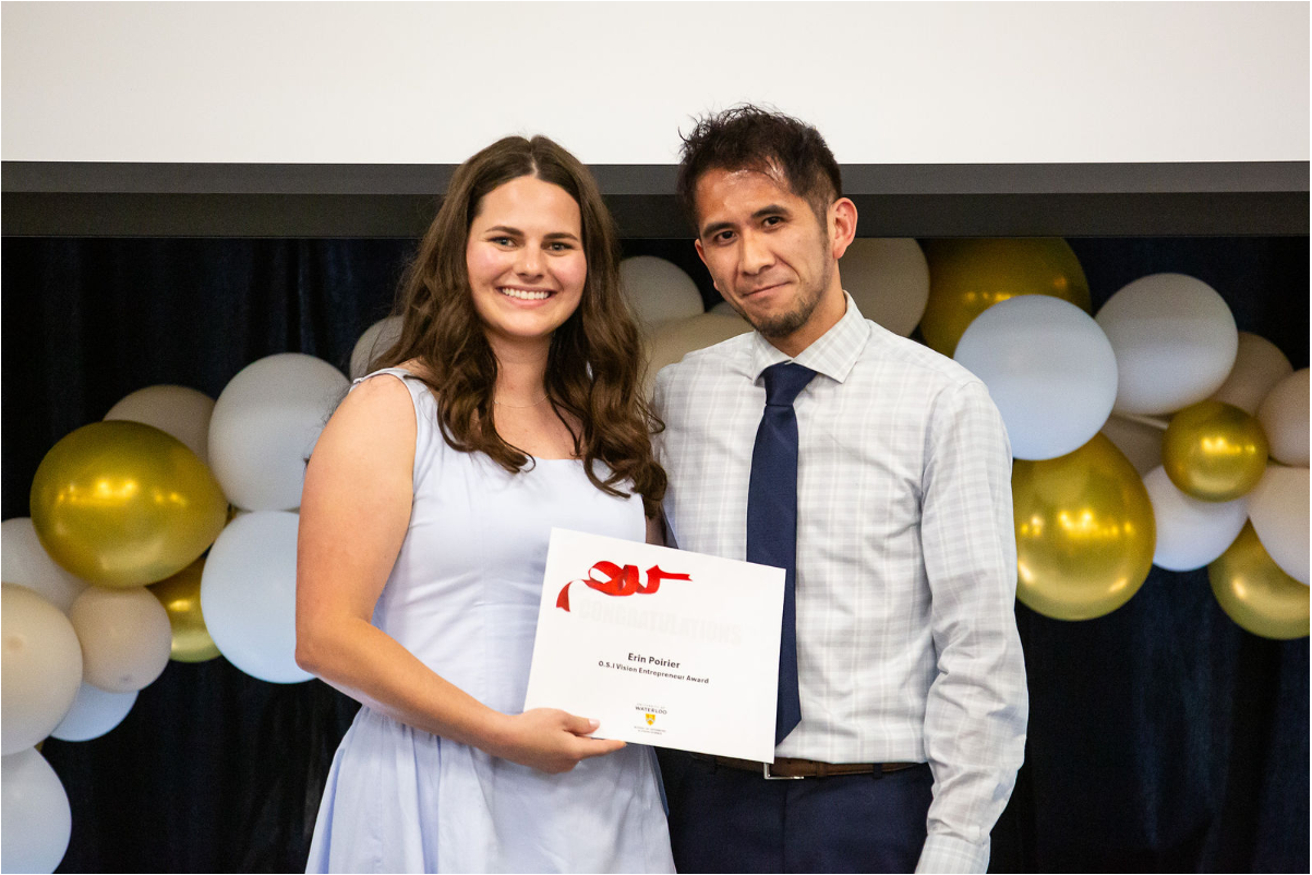 Erin Poirier holding the Vision Entrepreneur Award certificate